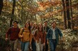 © Volodymyr Hankevych - Group of friends hiking in autumn forest with walking sticks