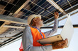 © Dusan Petkovic - Senior engineer with laptop in hands checking on electricity and cables under solar panels.