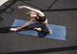 © Westend61 - Sportswoman with eyes closed doing stretching exercise on yoga mat