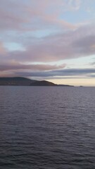 Wall Mural - peaceful ocean vista with distant mountains and a beautiful, colorful cloudy sky over british columb
