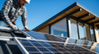 © oliamogdaleva - Worker installing solar panels on a modern house roof under blue sky. Renewable energy and sustainable living.