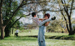 © qunica.com - A loving mother plays with her son in a picturesque park setting, surrounded by nature.