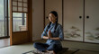 © nuttapon - A woman meditating in a room