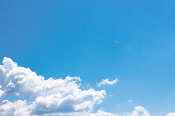 Wall Mural - white fluffy clouds on the azure blue sky. cumulus cloudscape in bright light in summer. weather background for vacation on a sunny day. cloudy atmosphere brings fresh air concept