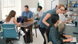 © Monkey Business - Multi-Cultural Business Team Working At Desks On Computers In Modern Open Plan Office