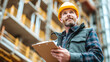 © venusvi - A construction manager inspects the building site with a clipboard while wearing a safety helmet, showcasing dedication and professionalism.