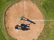 © Wavebreak Media - Diverse baseball players and umpire standing at home plate on baseball field holding bat and mitt