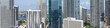 Aerial view of towering skyscrapers pierce the sky, reflecting the bright sunlight and azure waters of Biscayne Bay, Miami, Florida, United States.