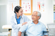 © whyframeshot - Asian healthcare professionals conduct medical consultations with senior patients using digital technology. Doctor examines elderly woman with stethoscope during comprehensive checkup
