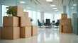 © Alex Pios - Cardboard boxes are stacked in a modern office hallway during a business relocation or move.
