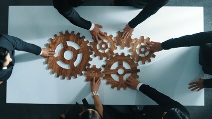 Wall Mural - top view of business people gather wooden cog together at meeting. group of project manager helping 