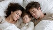 © ZinaZaval - A happy family enjoys a peaceful moment in bed, with smiling parents and a sleeping child, radiating warmth and love