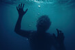 © MC Portfolio - Terrified man drowning underwater reaching toward surface in state of panic and desperation with bubbles rising in dark blue sea