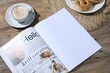 © New Africa - Open magazine, pretzels and coffee on wooden background, closeup. Mockup for design