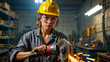 © Let it be - Medium shot of a confident female industrial worker in a yellow hard hat and safety glasses using an angle grinder with sparks in a factory.