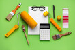 © Pixel-Shot - Composition with blank card, calculator and painting tools on green background. Renovation budget concept