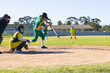 © Wavebreak Media - Male baseball players and umpire watching batter swinging metal bat at baseball near home plate