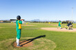 © Wavebreak Media - Man in green and yellow uniform standing in on-deck circle gripping bat on grass, copy space