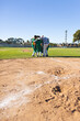 © Wavebreak Media - Diverse male baseball team huddling on pitcher mound wearing green and yellow jerseys