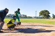 © Wavebreak Media - Diverse baseball players swinging bat, crouching with mitt and pitching at baseball field