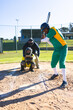 © Wavebreak Media - Diverse umpire and players at home plate, batter swinging bat, catcher holding mitt, copy space