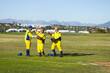 © Wavebreak Media - Diverse male teammates celebrating play near foul line on baseball field with gloves and caps