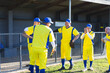 © Wavebreak Media - Male baseball teammates huddling beside dugout fence at baseball field holding bat and glove