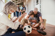 © Marko Geber - Multigenerational caucasian family being playful and having fun on a balcony of their house