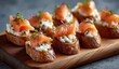 © pipa - Appetizer bites of toasted bread topped with smoked salmon and creamy cheese, garnished with fresh herbs
