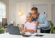© Fahng - Lovely senior couple relax in living room enjoying retirement and free time browsing on laptop. Older generation and wireless technology users concept.