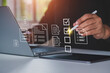 © LAONG - Businessman mark off items on digital checklist, Quality assurance technology, representing document control processes, verification and compliance, Working electronic smart document on virtual screen