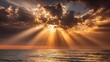 © Boonnam Burart - Light beams piercing through clouds above wide ocean expanse