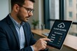 © Татьяна Евдокимова - Businessman in an office setting using a tablet to manage cloud access permissions, focusing on security and data management