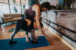 © qunica.com - A male instructor assists a female participant during a yoga session in a cozy studio environment, surrounded by comfortable furnishings and a calming atmosphere, fostering wellness and relaxation.