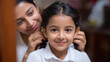 © Niks Ads - young indian woman braiding daughter hair