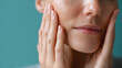 © Marut - Soft hands gently massaging face with dewy skin close up, showing natural texture and healthy complexion in calming skincare moment. Relaxed expression with smooth, hydrated skin glow