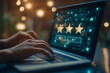 © Tahsina - A close-up of a customer's hand using a laptop computer shows a glowing star icon on a virtual screen, as they write an online review sharing a positive platform experience
