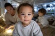 © Milos - A serene moment captured with two small children playing joyfully inside a blanket fort while a parent engages with them, creating a delightful and warm atmosphere.