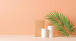 © TouheedAhmed - White product containers and box on a peach background with a palm leaf