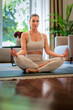 © sepy - Middle aged woman practicing yoga at home