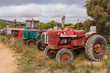 © Austockphoto - Colourful old tractors parked in a line
