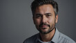 © Faraz-9461894 - A handsome mature man with gray hair and a beard poses for a portrait in a studio setting with a casual shirt.