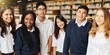 © Rawpixel.com - Group of diverse students in uniform in school library work on group project. Diverse students work together on group project in library. High school education photo, group of happy diverse students