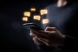 © Pavel - Person holding a smartphone with glowing chat icons in a dark environment while engaging in digital communication during the evening hours