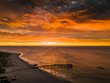 © AmazingAerialAgency - Aerial view of the pier stretching into the tranquil ocean under a fiery sunset sky, Western Australia, Western Australia, Australia.