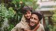 © Johannes - Happy indian father giving piggyback ride to his son and looking at camera. Cute ethnic boy with dad playing outdoor. Close up face of handsome man carrying on shoulders his middle eastern kid., no l