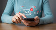 © Sameed - Woman checks email inbox on smartphone, managing digital communications