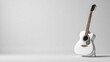 © yasiryasir - White acoustic guitar on a stand against a plain white background