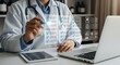 © Kasun - Healthcare professional reviewing patient medical records on a digital interface at a modern clinic desk