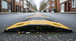 © RIKO - Urban Slowdown Black And Yellow Speed Bump In A Quiet Neighborhood Street